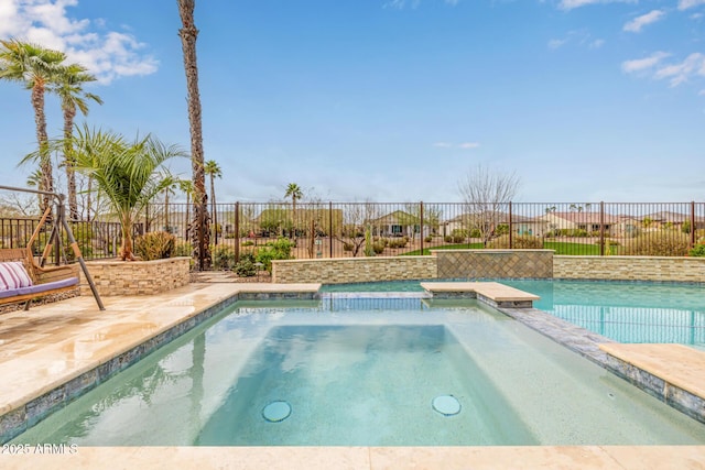 view of swimming pool with a patio area, fence, and a pool with connected hot tub