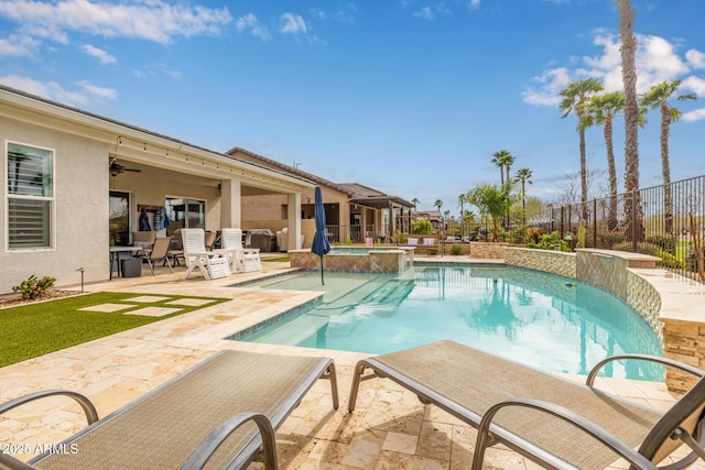 view of pool with a pool with connected hot tub, a patio area, fence, and ceiling fan