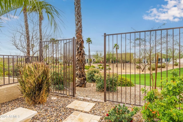 view of gate featuring a yard