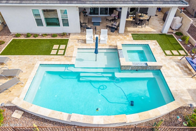 view of pool with a fenced backyard, a pool with connected hot tub, a lawn, outdoor dining space, and a patio area