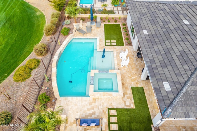 view of pool with a patio area, a pool with connected hot tub, and a fenced backyard