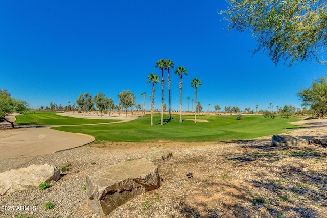 view of home's community with a lawn and golf course view