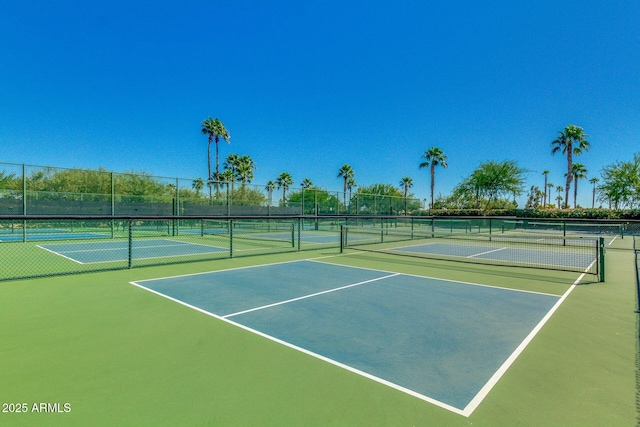 view of tennis court with community basketball court and fence