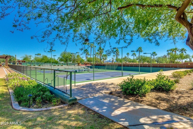 view of sport court featuring fence