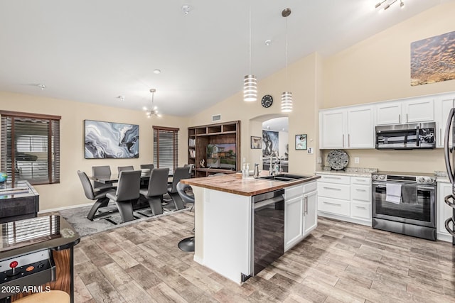 2108 E Patrick Ln, Phoenix, AZ 85024 - kitchen featuring appliances with stainless steel finishes, wood counters, light wood-type flooring, white cabinets, and high vaulted ceiling