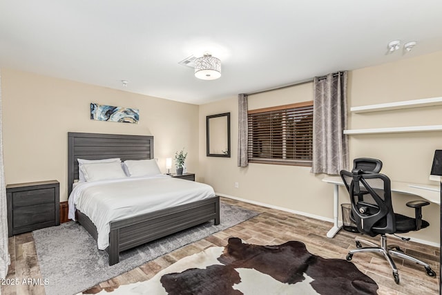 2108 E Patrick Ln, Phoenix, AZ 85024 - bedroom featuring wood finished floors and a desk