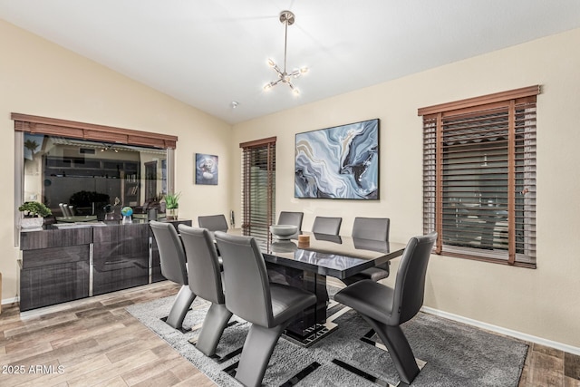 2108 E Patrick Ln, Phoenix, AZ 85024 - dining room with wood finished floors, lofted ceiling, and a chandelier