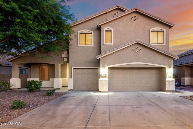 46065 W Meadows Ln, Maricopa, AZ 85139 - mediterranean / spanish house featuring stucco siding, concrete driveway, an attached garage, and a tile roof