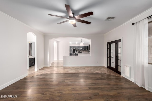 46065 W Meadows Ln, Maricopa, AZ 85139 - unfurnished living room with crown molding, ceiling fan, arched walkways, wood finished floors, and french doors