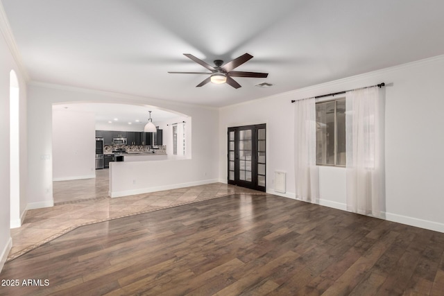 46065 W Meadows Ln, Maricopa, AZ 85139 - unfurnished living room featuring a ceiling fan, light wood-style flooring, ornamental molding, french doors, and arched walkways