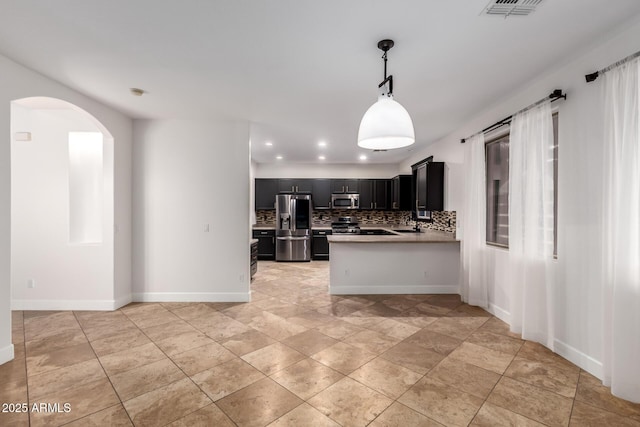 46065 W Meadows Ln, Maricopa, AZ 85139 - kitchen featuring appliances with stainless steel finishes, dark cabinetry, backsplash, light countertops, and recessed lighting