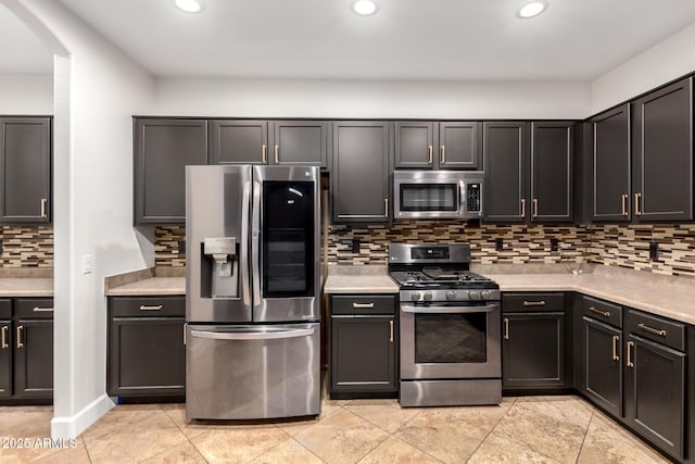 46065 W Meadows Ln, Maricopa, AZ 85139 - kitchen with appliances with stainless steel finishes, arched walkways, light countertops, decorative backsplash, and recessed lighting