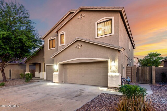 46065 W Meadows Ln, Maricopa, AZ 85139 - mediterranean / spanish home with an attached garage, stucco siding, driveway, a gate, and a tiled roof