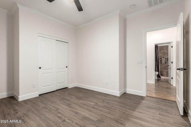 46065 W Meadows Ln, Maricopa, AZ 85139 - unfurnished bedroom featuring crown molding, wood finished floors, a closet, and a ceiling fan