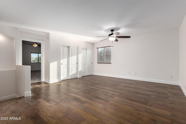 46065 W Meadows Ln, Maricopa, AZ 85139 - unfurnished room with ceiling fan, dark wood-type flooring, and arched walkways
