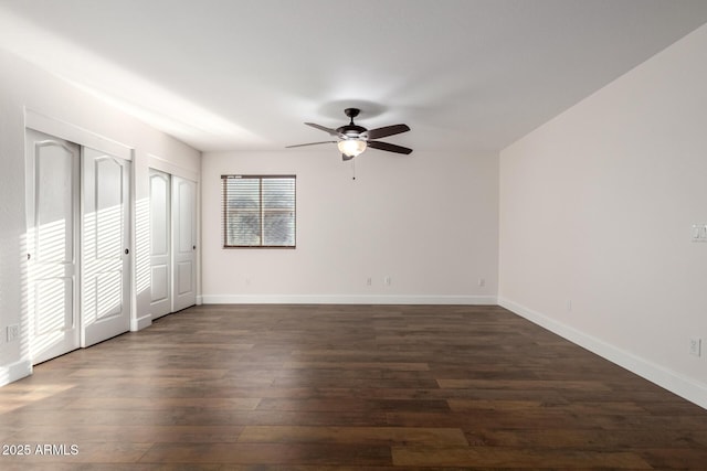 46065 W Meadows Ln, Maricopa, AZ 85139 - unfurnished bedroom with dark wood-style floors, two closets, and a ceiling fan