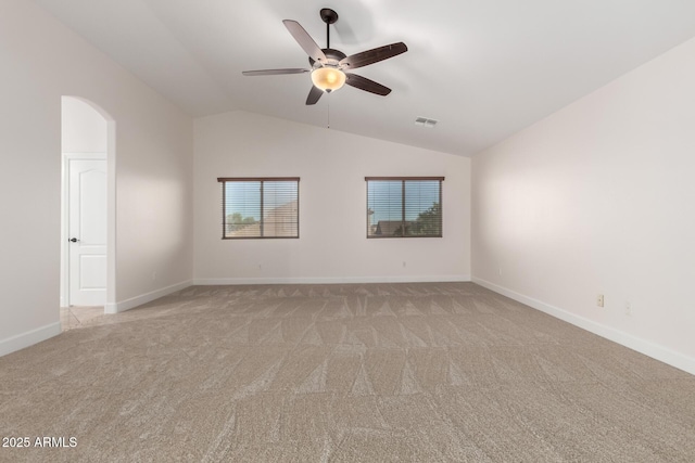 46065 W Meadows Ln, Maricopa, AZ 85139 - spare room with light carpet, lofted ceiling, ceiling fan, and arched walkways