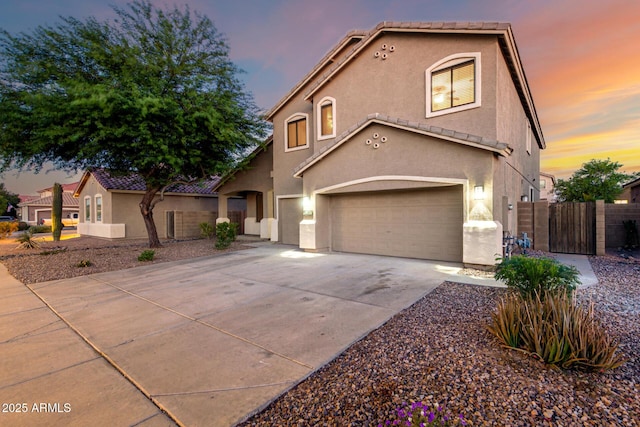 46065 W Meadows Ln, Maricopa, AZ 85139 - mediterranean / spanish-style home with stucco siding, concrete driveway, a gate, and an attached garage