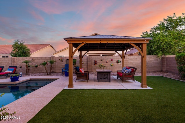 46065 W Meadows Ln, Maricopa, AZ 85139 - patio terrace at dusk with a gazebo, a patio area, and a fenced backyard
