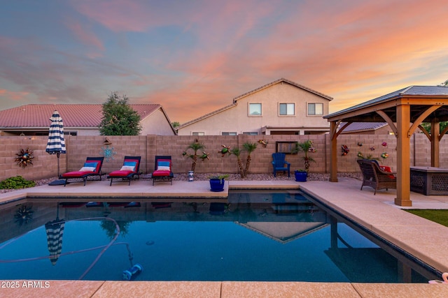 46065 W Meadows Ln, Maricopa, AZ 85139 - pool at dusk with a patio, a gazebo, and a fenced backyard