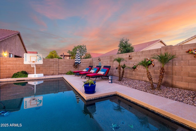46065 W Meadows Ln, Maricopa, AZ 85139 - pool at dusk with a fenced backyard and a patio