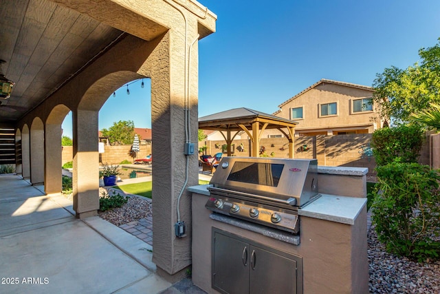 46065 W Meadows Ln, Maricopa, AZ 85139 - fenced backyard with a gazebo, a patio, and exterior kitchen