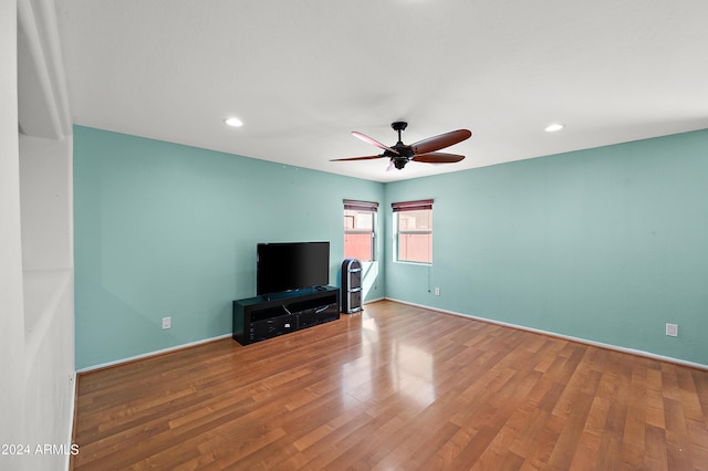 unfurnished living room featuring recessed lighting, ceiling fan, baseboards, and wood finished floors