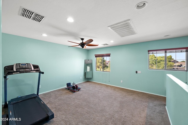 workout room with carpet flooring, visible vents, and baseboards