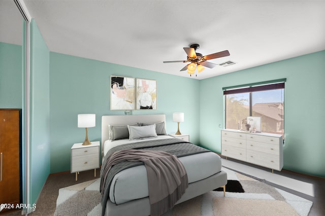 bedroom with baseboards, carpet, visible vents, and a ceiling fan