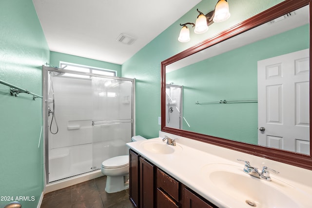 bathroom featuring visible vents, a sink, a shower stall, and toilet