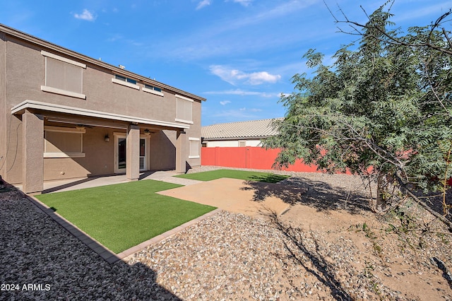 view of yard with a ceiling fan, a patio area, and a fenced backyard