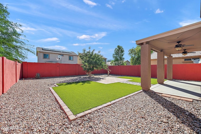 view of yard with a patio area, a fenced backyard, and a ceiling fan