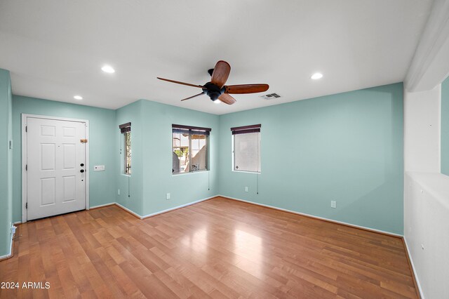 spare room featuring light wood-type flooring, visible vents, baseboards, and recessed lighting