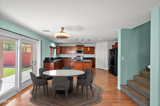 dining room with stairs, light wood finished floors, visible vents, and recessed lighting