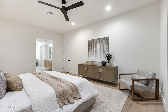 bedroom featuring light hardwood / wood-style flooring, connected bathroom, and ceiling fan