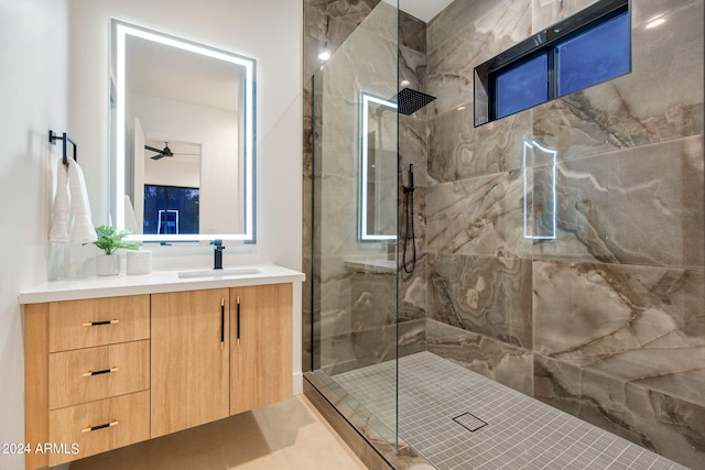 bathroom featuring oversized vanity, ceiling fan, an enclosed shower, and tile floors