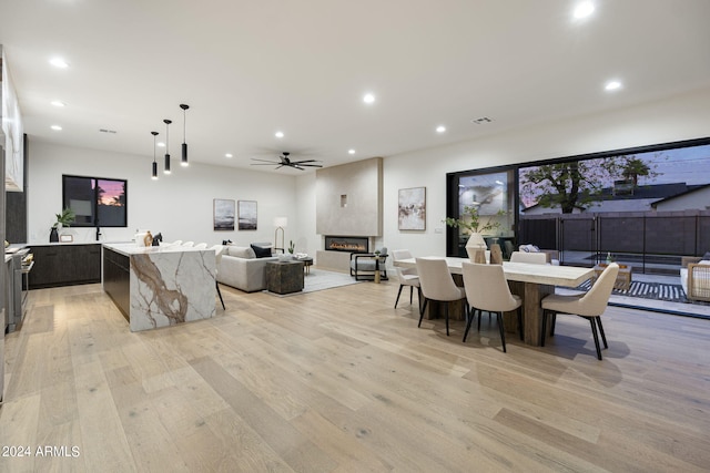 dining space featuring ceiling fan and light wood-type flooring