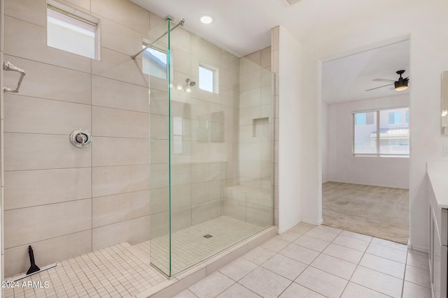 bathroom featuring tile patterned flooring, ceiling fan, and a shower stall