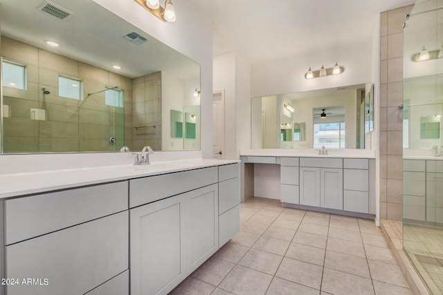 bathroom with a stall shower, a sink, and visible vents