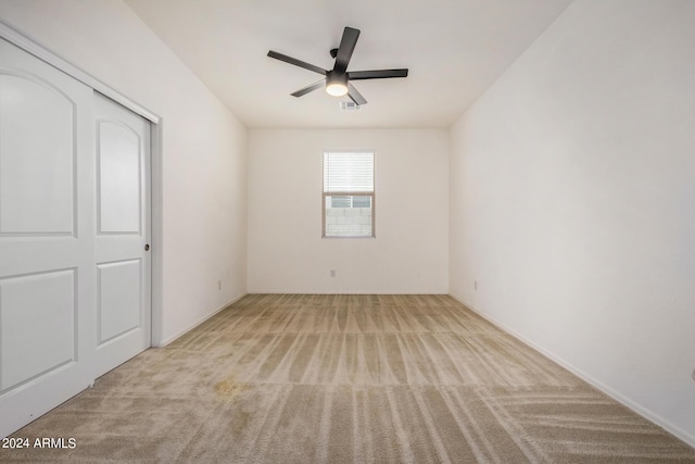 unfurnished bedroom featuring carpet floors, visible vents, and a ceiling fan