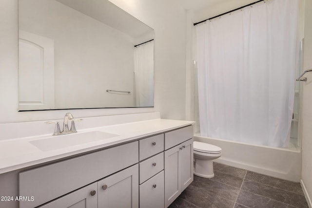 full bath featuring toilet, shower / bath combo with shower curtain, and vanity