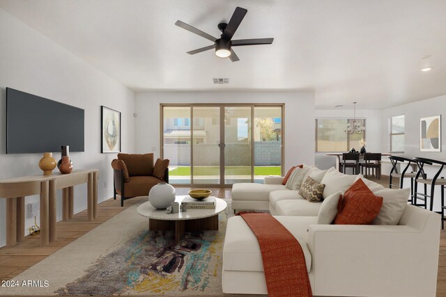 living room featuring light hardwood / wood-style flooring and ceiling fan