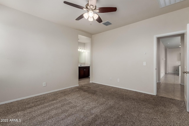 empty room with ceiling fan, baseboards, visible vents, and carpet