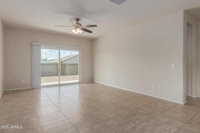 empty room with visible vents, baseboards, ceiling fan, and light tile patterned flooring