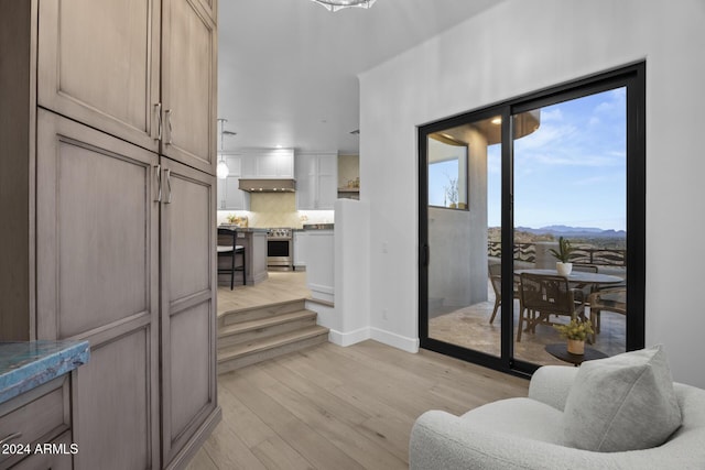 interior space with a mountain view and light wood-type flooring