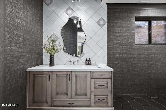 bathroom featuring vanity and tile walls