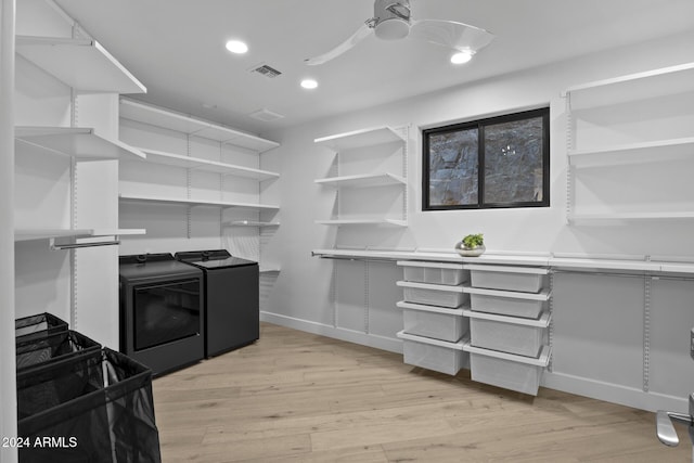 kitchen with washer and dryer, ceiling fan, and light wood-type flooring