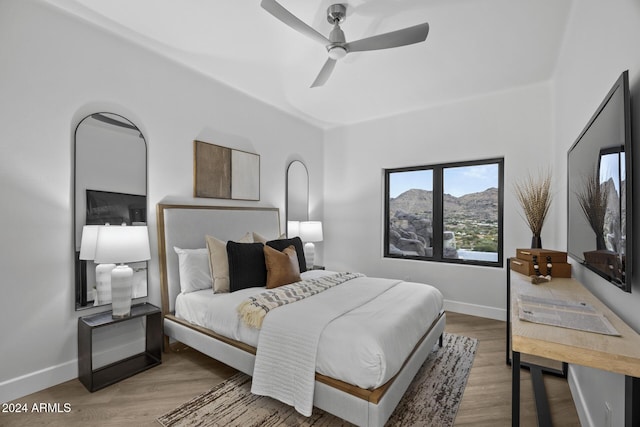 bedroom with hardwood / wood-style floors and ceiling fan