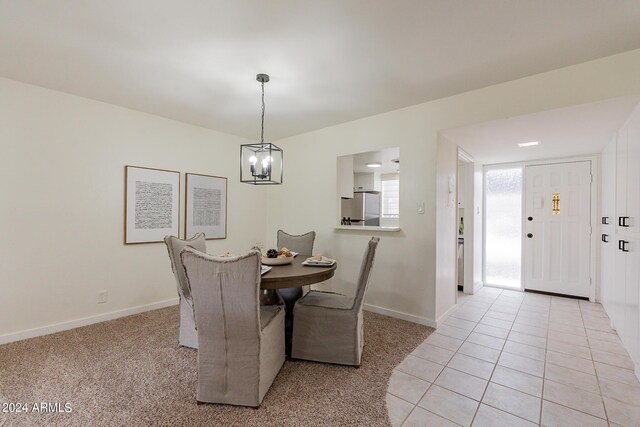 dining area with a notable chandelier and light tile patterned floors