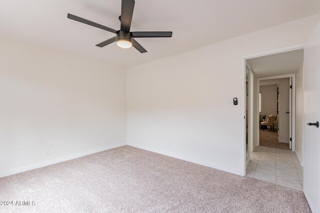 carpeted empty room with ceiling fan